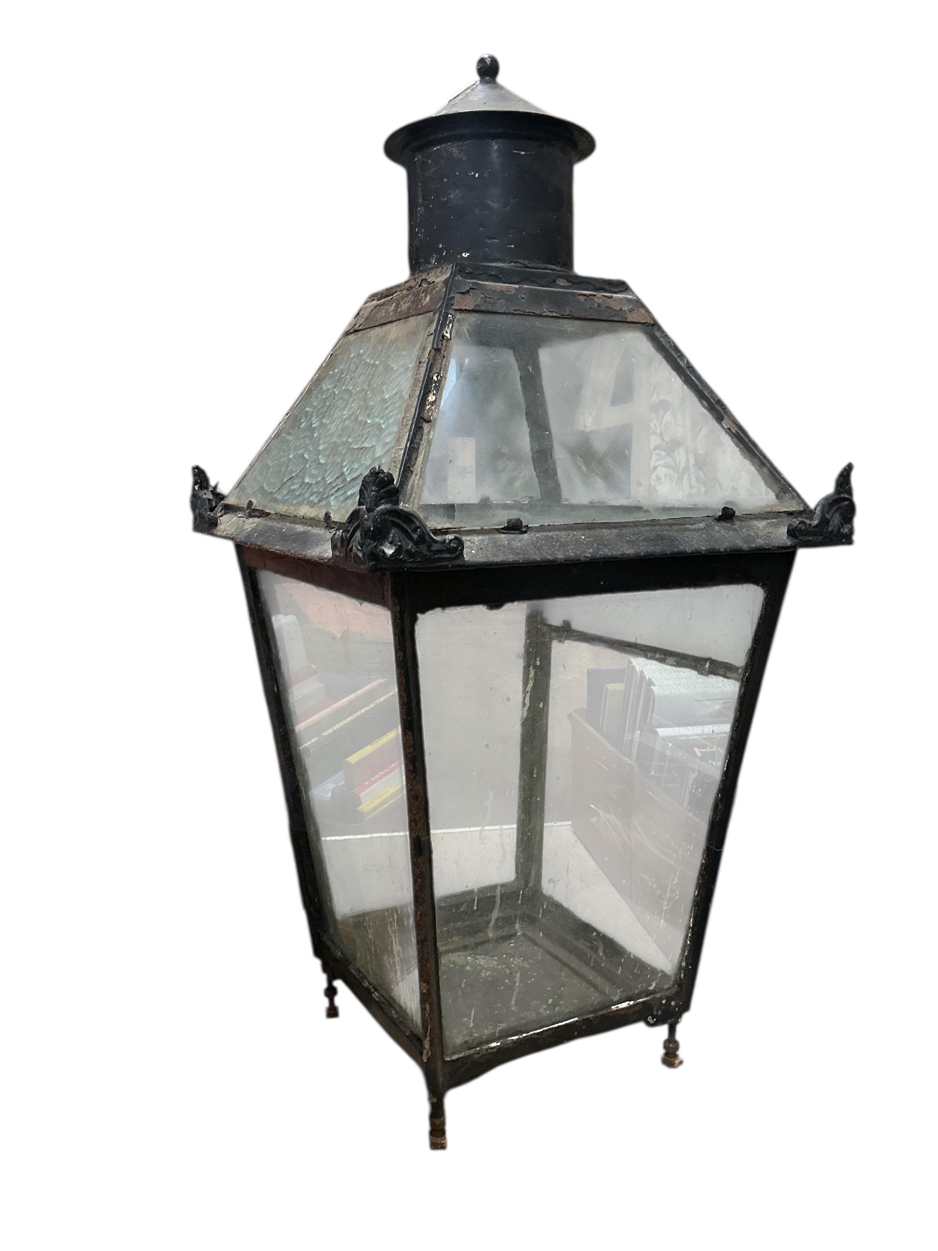 A glass and steel railway station lantern with an opaque glass panel showing the remains of a painted possible station name, missing the burner etc., 80cm high, 40cm wide